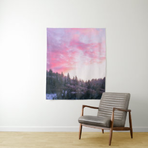 Magical bright pink sunset above snowy forest tapestry