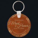 Maid of Honour Wedding Gift Rust Orange & Gold Key Ring<br><div class="desc">These keychains are designed to give as favours to the Maid of Honour in your wedding party. They feature a simple yet elegant design with a rust orange or burnt umber coloured background, gold text, and a lacy golden faux foil floral border. The text reads "Maid of Honour" with space...</div>