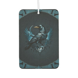 Majestic black raven sitting on an ornate car air freshener
