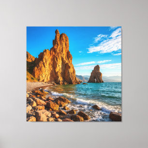 Majestic Coastal Rock Against a Bright Blue Ocean Canvas Print