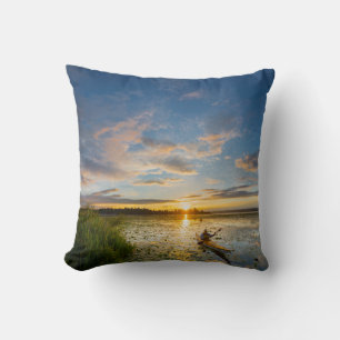 Male kayaker paddling sea kayak on still water cushion