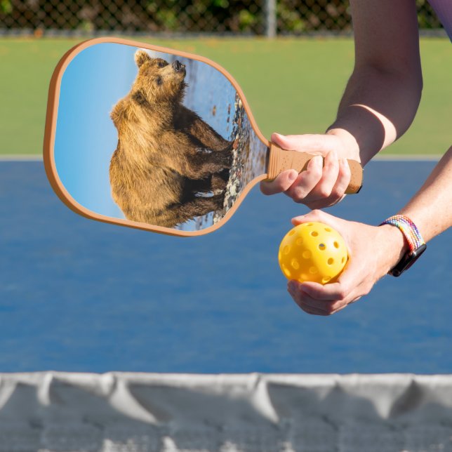 Mama bear watching her two kids pickleball paddle (Insitu)