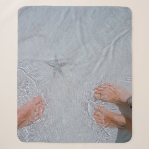 Man and woman on seashore nearby starfish sherpa blanket