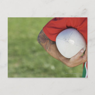Man carrying rugby ball postcard