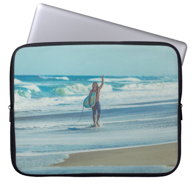 Man carrying surfboard at beach laptop sleeve (Front)