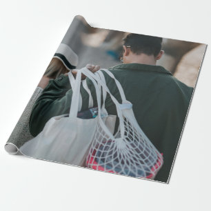 Man carrying white bags wrapping paper