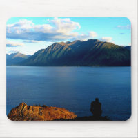 Man Crouches Contemplating Sunset Light in Alaska