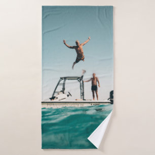 Man diving on pool bath towel