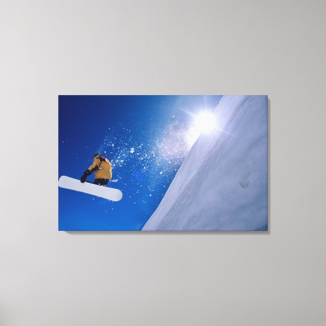 Man flying through the air on a snowboard with canvas print (Front)