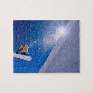 Man flying through the air on a snowboard with jigsaw puzzle