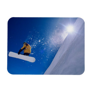 Man flying through the air on a snowboard with magnet