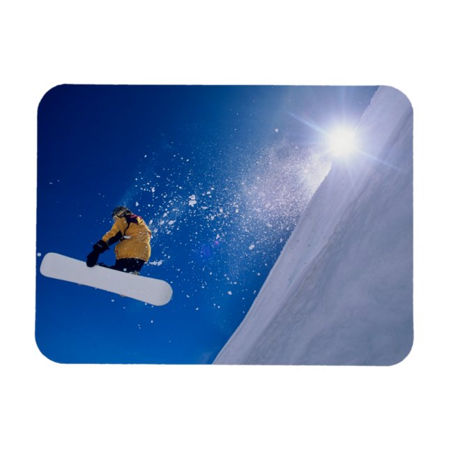 Man flying through the air on a snowboard with magnet (Horizontal)