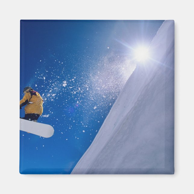 Man flying through the air on a snowboard with magnet (Front)