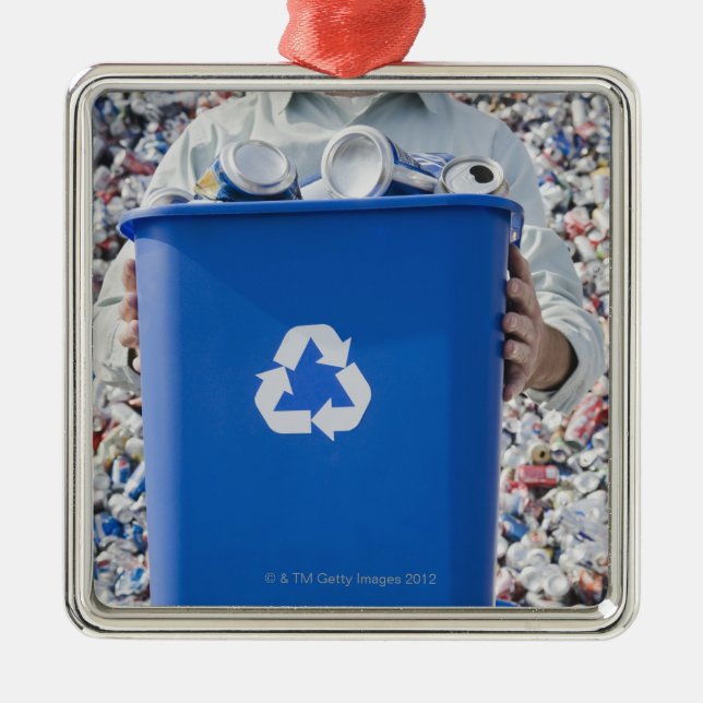 Man holding blue bin metal tree decoration (Front)