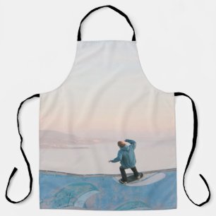 Man in blue skateboarding on wall in beach apron