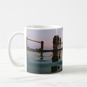Man jump in mid air on body of water coffee mug