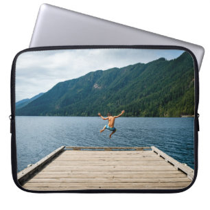 Man jumping near sea laptop sleeve