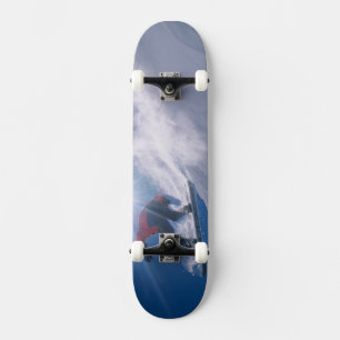 Man jumping off a large cornince on a snowboard skateboard