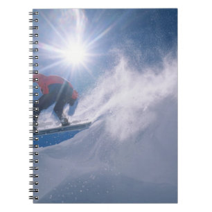 Man jumping off a large cornince on a snowboard spiral notebook