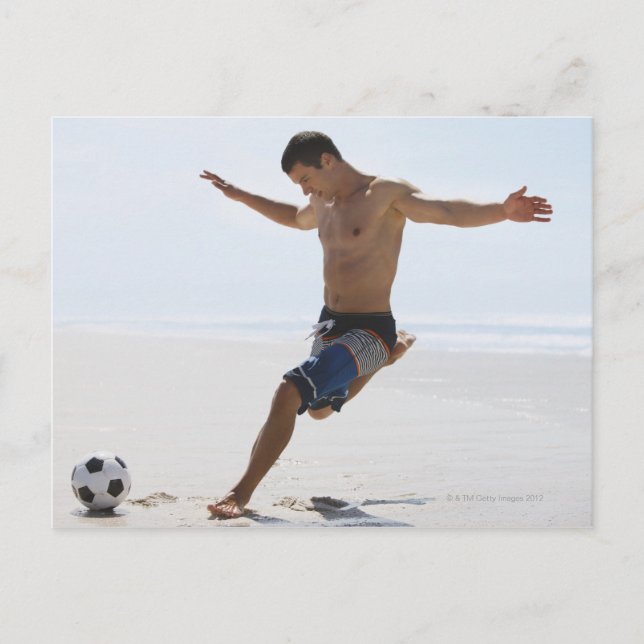 Man kicking soccer ball on beach postcard (Front)