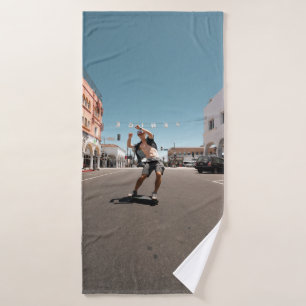 Man playing skateboard bath towel