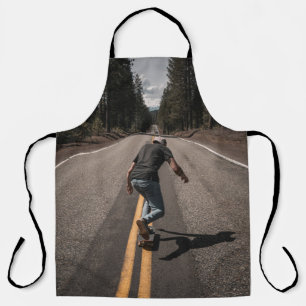 Man playing skateboard on road in the morning apron