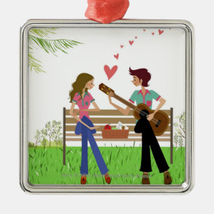 Man playing the guitar with a woman beside her metal tree decoration