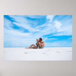 Man sitting beside of woman in black bikini top poster