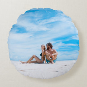 Man sitting beside of woman in black bikini top round cushion