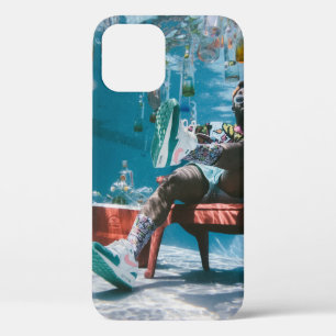 Man sitting on chair underwater with floating bott iPhone 12 case