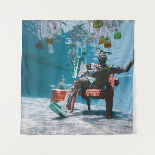 Man sitting on chair underwater with floating bott tapestry (Front)