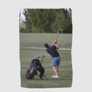 Man swinging a Golf club Towels