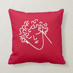 man with curly hair red cushion