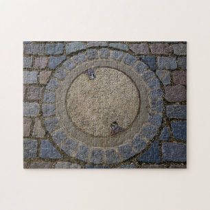 Manhole cover and cobblestone road jigsaw puzzle