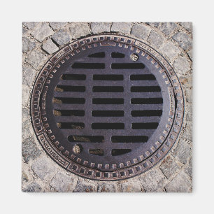 Manhole cover and cobblestone road magnet