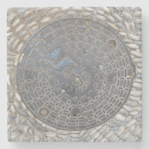 Manhole cover and cobblestone road stone coaster