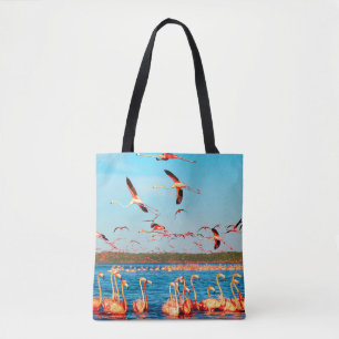 Many pink beautiful flamingos in a beautiful blue tote bag