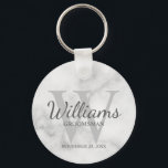 Marble Personalised Script Groomsmen Key Ring<br><div class="desc">Add a personal touch to your wedding with personalised groomsmen keychain. This keychain features personalised groomsman's name in grey classic script font style with wedding details in grey classic serif font style and monogram in light grey classic serif font style as background, on white marble background. Also perfect for best...</div>