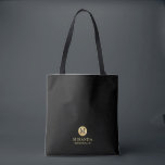 Masculine Black and Gold Personalised Bridesmaid Tote Bag<br><div class="desc">Add a personal touch to your wedding with personalised bridesmaid tote bag. This tote bag features black monogram in gold circle element with name and title in gold professional font style on black background. Also perfect for maid of honour, flower girl and more. Please Note : The foil details are...</div>