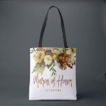 Matron of honour autumn fall wedding rustic bridal tote bag<br><div class="desc">Modern rustic matron of honour tote bag featuring autumn fall rusty orange gold and ivory cream flowers with dried leaves and foliage and a whimsical chic typography script.             Personalise it with matron's name on the front side and with the wedding couple names and date on the reverse.</div>