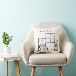Meditation chair by window with plant and throw cushion