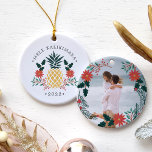 Mele Kalikimaka | Hawaiian Christmas Photo Ceramic Tree Decoration<br><div class="desc">Festive holiday ornament features a Christmas pineapple illustration flanked by red poinsettia flowers and green holly,  with the Hawaiian Christmas greeting "Mele Kalikimaka" curved above. Personalise with the year for a tropical chic holiday keepsake,  and add a favourite photo to the reverse side,  surrounded by matching lorals and branches.</div>