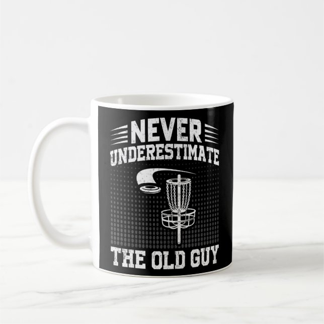 Mens Disc Golf  Never Underestimate The Old Guy 7  Coffee Mug (Left)