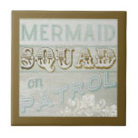 Mermaid Squad on Patrol Tile<br><div class="desc">Mermaid Squad on Patrol. This cool piece of art is brought to you by World Art Group, a featured work of June Erica Vess. Set on a rustic wood themed background with subtle imprint patterns, this is a girly classic with bold, inviting gold lettering to really bring the fun to...</div>