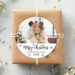 Merry Christmas Black White Snowflake Family Photo Classic Round Sticker<br><div class="desc">Modern Script Black and White "Merry Christmas" Calligraphy Script Family Photo Christmas Holiday Round Sticker. Features cute snowflakes (snowy) background,  family name and year. Great for Mailing Accessories Envelope Seals and Gift Stickers.</div>