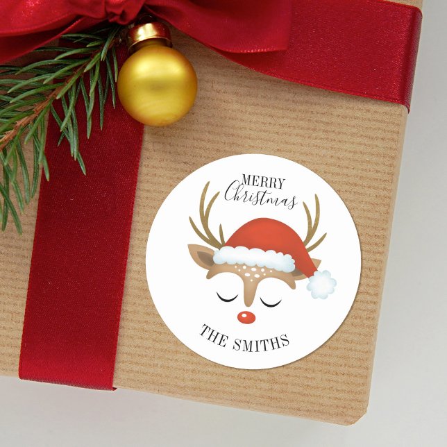 Merry Christmas Cute Reindeer Classic Round Sticke Classic Round Sticker (A cute Reindeer with a Santa hat decorates this Christmas Sticker. Fun for your kids presents.)