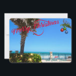 Merry Christmas from Vero Beach Florida Oceanfront Holiday Card<br><div class="desc">Merry Christmas from Vero Beach, Florida! This colourful tropical-themed flat greeting card features a photo image of a beautiful Vero Beach oceanfront area all decked out for the holidays. The festive design includes Christmas lights on the greenery, Christmas balls hanging from a palm frond, and the text "Merry Christmas" in...</div>