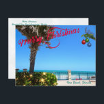 Merry Christmas from Vero Beach Florida Oceanfront Holiday Postcard<br><div class="desc">Merry Christmas from Vero Beach, Florida! This colourful tropical-themed postcard features a photo image of a beautiful Vero Beach oceanfront area all decked out for the holidays. The festive design includes Christmas lights on the greenery, Christmas balls hanging from a palm frond, and the text "Merry Christmas" in red script...</div>
