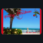 Merry Christmas from Vero Beach Florida Oceanfront Magnet<br><div class="desc">Merry Christmas from Vero Beach, Florida! This colourful tropical-themed flexible magnet features a photo image of a beautiful Vero Beach oceanfront area all decked out for the holidays. The festive design includes Christmas lights on the greenery, Christmas balls hanging from a palm frond, and the text "Merry Christmas" in red...</div>