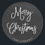 Merry Christmas | Handwritten Script on Chalkboard Classic Round Sticker<br><div class="desc">This simple and trendy holiday sticker says "Merry Christmas" in rustic,  white handwritten script on a black,  chalkboard look background.</div>